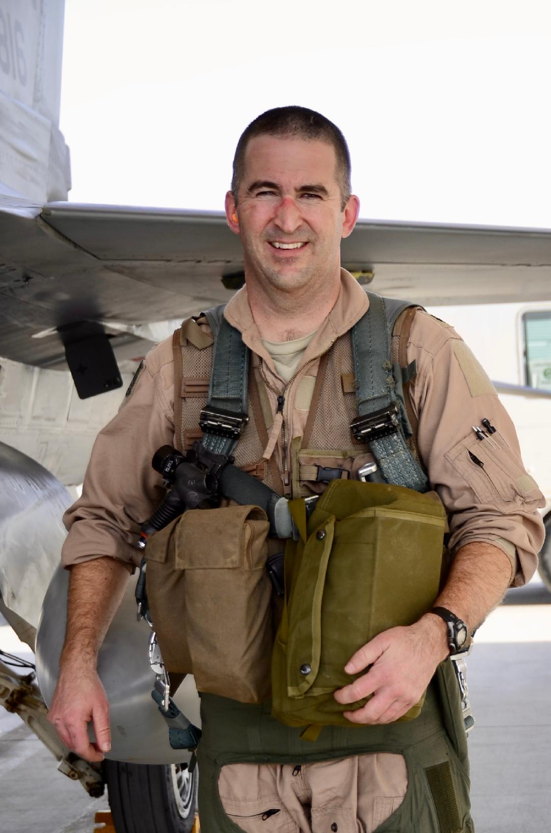 The author in flight gear next to an F-16.