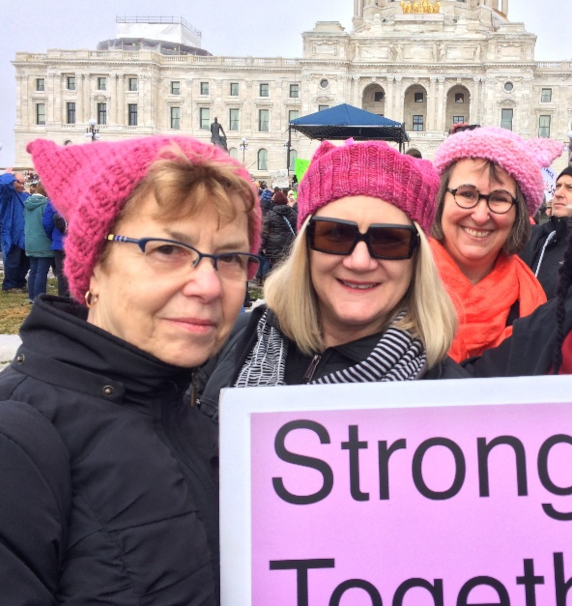 photo of the author with 2 friends at the MN State Capitol wearing pink knit pussyhats