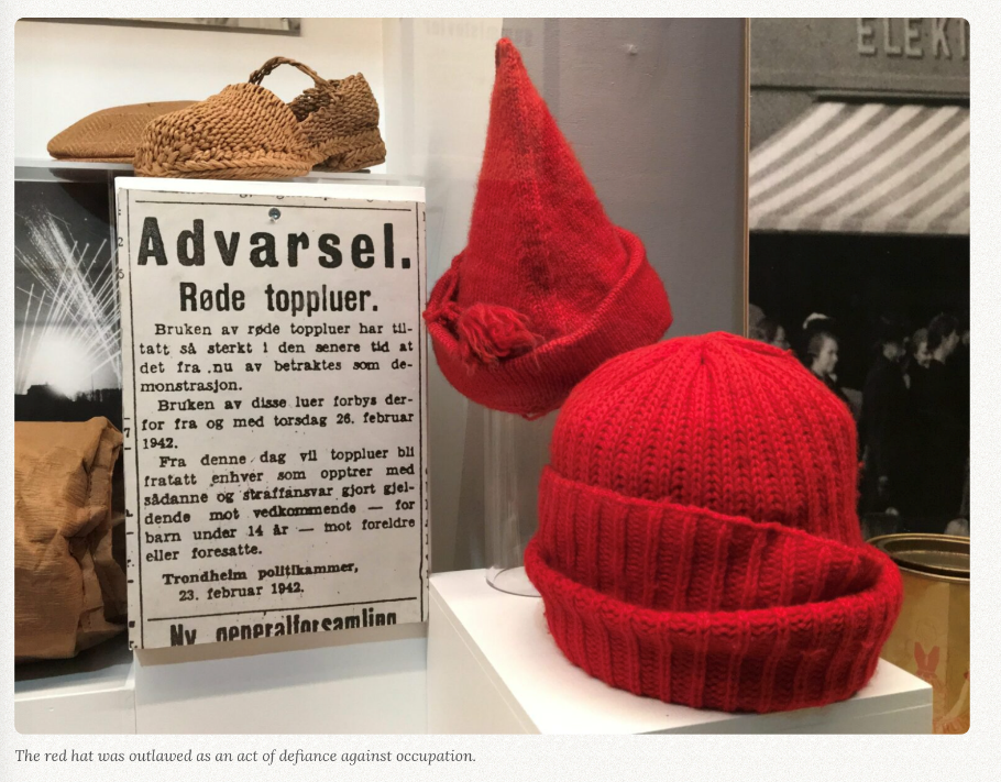 Red knit hats in museum exhibit, outlawed by Nazi occupiers of Norway.