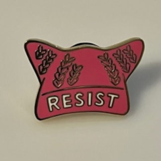 cloisonné pin depicting pussyhat marked "Resist"